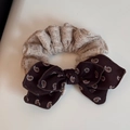 Detailed macro view of retro paisley pattern bowknot and beige textured fabric headband - Scrunchie / Paisley Bow Scrunchie - Beige Coffee
