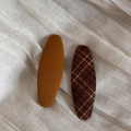 Detail of two oval fabric BB hair clips in solid yellow and brown plaid patterns - Brown Series Pair - Large Oval