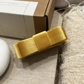 Detailed close-up of a mustard yellow velvet double bow hair clip with rich texture - Yellow