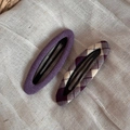 Detailed view of purple fabric and plaid pattern BB hair clips on linen cloth - Purple Series Pair - Hollow Oval
