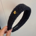 Detail of plush black headband with golden bear charm and handmade inner label - Black