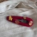 Detailed close-up of burgundy felt hair clip with golden Chinese traditional lucky charms - New Year Hair Clip - Hollow Water Drop (FJ891931)