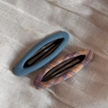 Detail showing blue denim and plaid fabric textures on oval BB hair clips - Blue Series Pair - Hollow Oval
