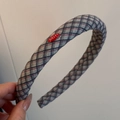 Close-up of a padded plaid headband featuring classic grey, navy, and red fabric texture - Blue Gray Plaid Headband