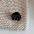 Close-up of a small black glossy acetate hair claw clip on beige knitted fabric - Cloud Small Claw-Black