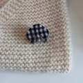 Macro shot of a mini black and white gingham acetate hair claw clip on knit fabric - Cloud Small Claw-Checkerboard