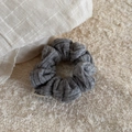Close-up of grey knitted headband texture with premium woven fabric and side brand label - Cable Knit Scrunchie-Gray