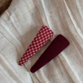 Detail view of red plaid fabric and wine red velvet teardrop BB hair clips on linen cloth - Red Plaid And Dark Red Triangle Style