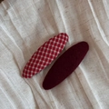 Close-up of red plaid fabric and burgundy velvet oval snap hair clips on linen cloth - Red Plaid And Dark Red Oval Style