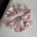 Detail of light pink pleated hair scrunchie showing fine accordion texture and soft sheen - Pink