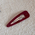 Close-up of deep wine red acetate teardrop hair clip with France Handmade gold lettering - Red