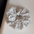 Detailed close-up of a white and black checkered cotton hair scrunchie with soft pleats - Vintage Grid White Scrunchie
