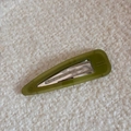 Detailed macro view of olive green acetate hair clip with France Handmade lettering - Green