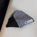 Macro shot of Gingham fabric headpiece showing white zigzag stitching and logo label - Checkered Triangular Claw