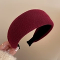 Detail of burgundy knitted thick headband showing texture and non-slip interior lining - Red