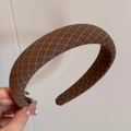 Close-up of brown plaid fabric headband showing vintage texture and interior label details - Headband / Brown