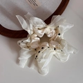 Close-up of cream silk scrunchie with black polka dots and decorative ribbon bow - Ribbon Knot Polka Dot Style (Cream White) / Off White