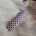 Close-up of lavender fabric hair clip with black polka dots on a linen background - Purple Fine Polka Dot Rectangle Style