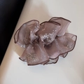 Detail view of dusty pink organza scrunchie with silver sequins and ruffled texture - Brown