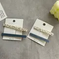Detail of rectangular hair clips with marble and blue texture on a white display card - Two-Piece Set / 8cm / Jelly Color