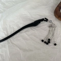 Detail of black wooden hair stick with silver lotus metal charm and tassel accents - Lotus Tassel