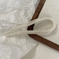 Detail of cream white acetate U-shaped hair pin featuring gold Creation France text logo - Mermaid White