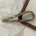 Detailed view of U-shaped acetate hair pin with elegant marble pattern texture - Mixed Colors