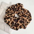 Detailed close-up of leopard print hair scrunchies with soft silky fabric texture - Dark Coffee Leopard