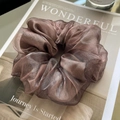 Detailed close-up of dark brown organza scrunchie with metallic luster and elegant pleats - Fuschia