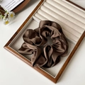 Elegant dark brown satin scrunchie with silky luster in a premium jewelry display tray - Brown