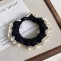 Detail of black satin scrunchie with white mesh trim and stylish black oval buckle - Black with Cream White Edge
