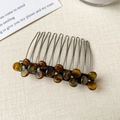 Detailed view of amber resin flower hair comb with silver metal teeth and rhinestones - Coffee Flower