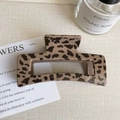 Detail of large leopard print hair claw clip with glossy resin finish on soft fabric - Light Leopard - Rectangle