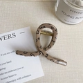 Detail of a khaki resin hair claw clip with black LOVE letters and heart print - Light Khaki LOVE Style