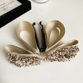 Dettaglio di un fermaglio per capelli in raso champagne con bordi in tweed e perla - Cachi