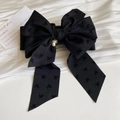 Detail view of a large black ribbon bow hair clip with an elegant pearl pendant - Black Ponytail Clip