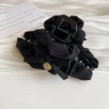 Close-up of black fabric hair claw clip with bow ribbon and golden butterfly pendant - Black Pleated Claw
