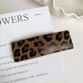 Macro shot of a rectangular leopard print hair clip on a minimalist ceramic plate - Leopard Print