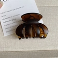 Detail view of a medium dark brown amber hair claw clip with a matte resin finish - Matte Amber
