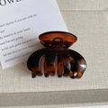 Detail of amber tortoiseshell hair claw clip with glossy finish and metal spring - Glossy Caramel