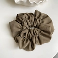 Detail of olive green oversized scrunchie with handmade gold metal tag decoration - Light Coffee