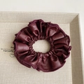 Detail shot of a burgundy faux leather scrunchie with soft ruffled edges and fine texture - Wine Red Hair Tie