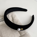Detailed close-up of a black velvet headband with a single white pearl and gold metal accent - Black - Headband