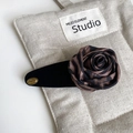 Macro detail of vintage leopard print silk rose hair clip with gold logo on beige linen - Leopard Rose Flocked BB Clip (9cm) / BB Clip 9cm / 9cm