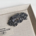 Detail of plush grey winter hair clip showing high-quality boucle texture and BB clip structure - Gray Long Cloud Style