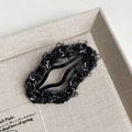 Detailed view of the wavy plush lamb wool fabric texture on a fashion BB hair clip - Black Cloud Style