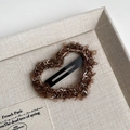 Close-up of heart-shaped plush hair clip featuring brown curly knit wool and metal BB clip - Coffee Heart Style