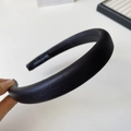 Close-up of handmade black padded sponge headband with premium faux leather texture - Black