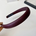 Detail view of burgundy faux leather sponge headband with handmade label inside - Fuschia