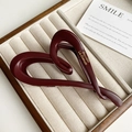 Detail of burgundy matte heart hair claw clip with golden lettering on jewelry tray - Wine Red Heart Style (FJ-1432)
